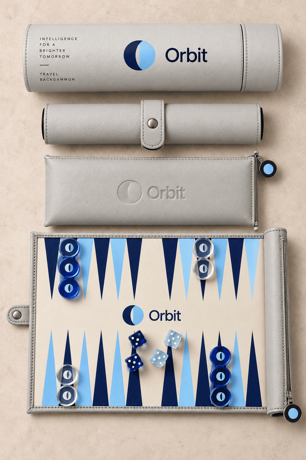 The signature roll-up set in Orbit livery — light grey leather tube and pouch with a navy crescent mark and a blue-and-navy backgammon board