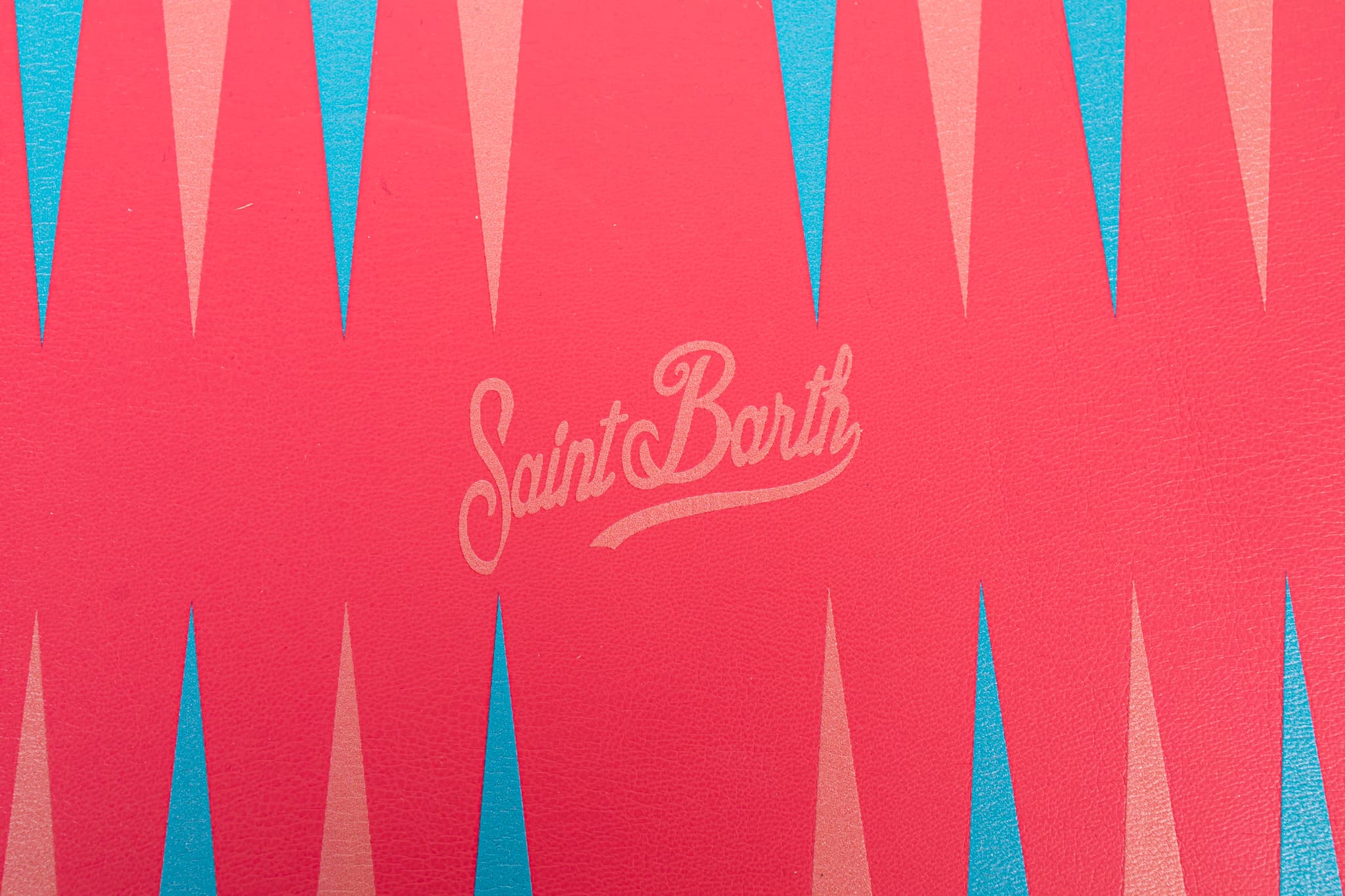 Coral leather backgammon board with Saint Barth branding and turquoise detailing