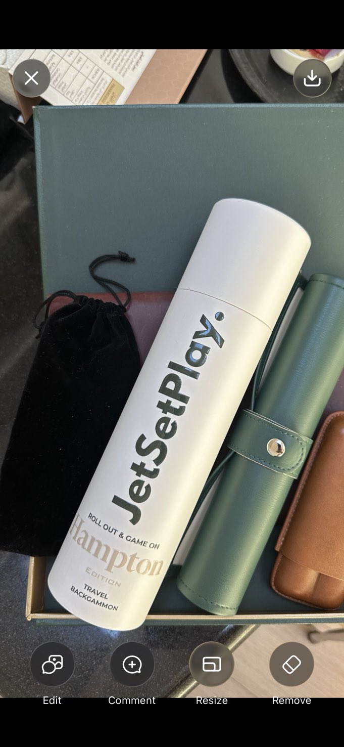 White JetSetPlay Hampton Edition travel backgammon tube packed in a gift box beside leather cases